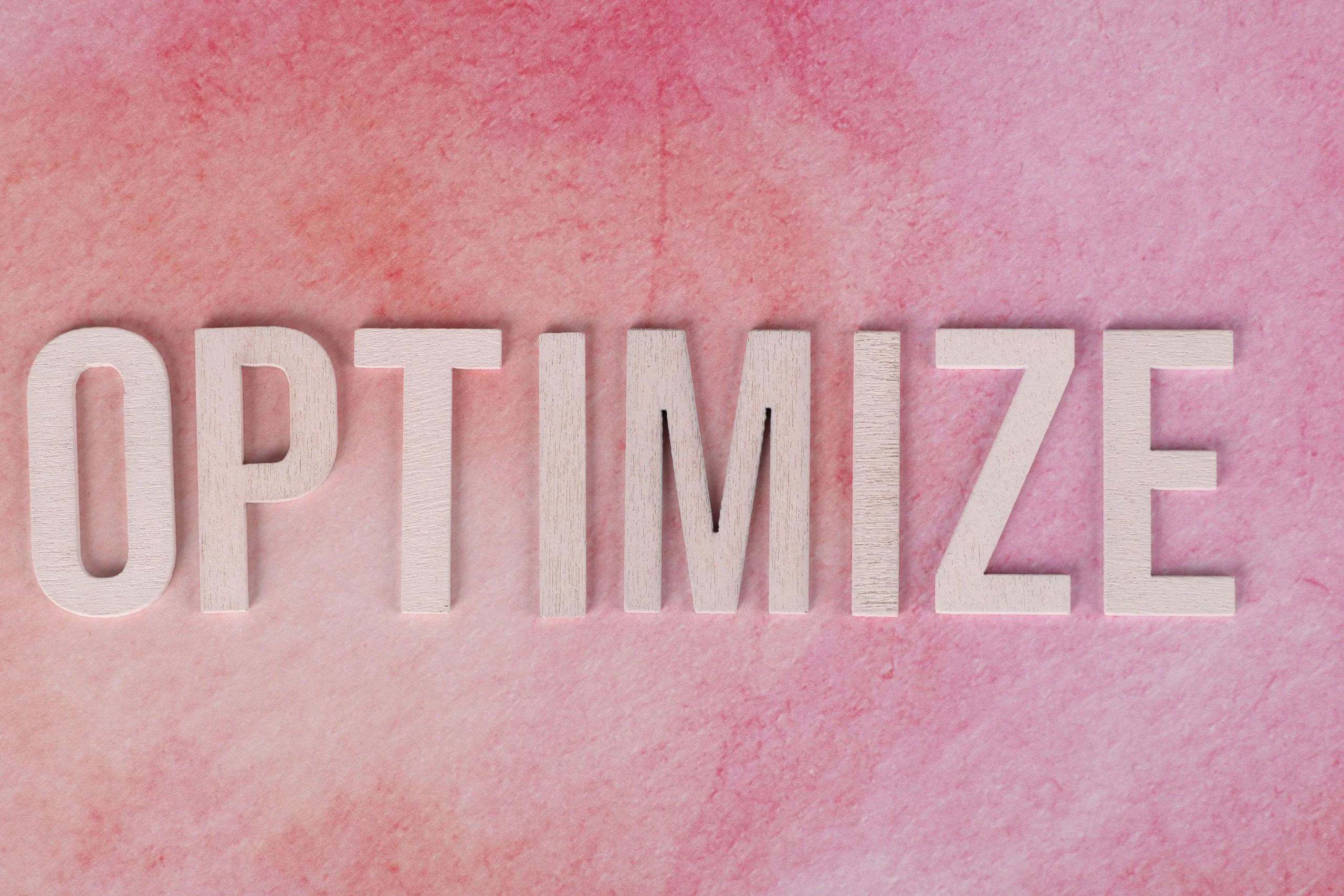 the word optimization with a pink background